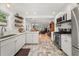 Modern kitchen featuring stainless steel appliances, white cabinets and view into the living area at 220 Sisson Ne Ave, Atlanta, GA 30317