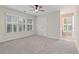 Bright bedroom with a ceiling fan and windows with shutter-style blinds at 230 Leaf Court, Alpharetta, GA 30005