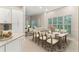 This dining room features a large wooden table, seating for eight, and windows covered by shutters at 230 Leaf Court, Alpharetta, GA 30005