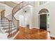 Grand foyer features hardwood floors, a curved staircase, and lots of natural light at 230 Leaf Court, Alpharetta, GA 30005