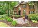 A beautiful landscaped front yard with a fountain and a bench create a welcoming outdoor space at 230 Leaf Court, Alpharetta, GA 30005