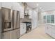 Modern kitchen with stainless steel appliances, sleek white cabinetry and ample storage at 230 Leaf Court, Alpharetta, GA 30005