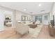 Comfortable living room with neutral decor, lots of light, and access to the bedroom at 230 Leaf Court, Alpharetta, GA 30005