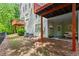 Exterior view of a backyard with covered patio and surrounding greenery at 4910 Longcourt Se Trce # 13, Atlanta, GA 30339