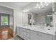 Bright bathroom with a double vanity and shower and a view into the main bedroom at 4910 Longcourt Se Trce # 13, Atlanta, GA 30339