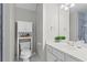 Bright bathroom featuring white vanity, cabinet, and a mirror at 4910 Longcourt Se Trce # 13, Atlanta, GA 30339