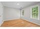 Well-lit bedroom with hardwood floors, crown molding, and plenty of natural light from two windows at 4910 Longcourt Se Trce # 13, Atlanta, GA 30339