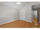Bedroom featuring hardwood floors, white walls, and ample closet space at 4910 Longcourt Se Trce # 13, Atlanta, GA 30339