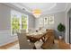 Elegant dining room featuring a decorative chandelier, large windows, and seating for six at 4910 Longcourt Se Trce # 13, Atlanta, GA 30339