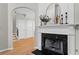 Close-up of a fireplace and mantel with decorative accents, next to an arched doorway at 4910 Longcourt Se Trce # 13, Atlanta, GA 30339