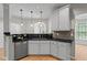 Stylish kitchen with sleek countertops, stainless steel appliances, and modern lighting fixtures at 4910 Longcourt Se Trce # 13, Atlanta, GA 30339