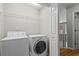 A laundry room featuring modern washer and dryer appliances at 4910 Longcourt Se Trce # 13, Atlanta, GA 30339