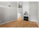 Bright living room with a cozy fireplace, hardwood floors, and soaring ceilings at 4910 Longcourt Se Trce # 13, Atlanta, GA 30339