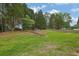 Large backyard with a fire pit area, shed, and mature trees at 516 Broad Head Pt, Suwanee, GA 30024