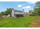 Expansive backyard with a covered patio, fire pit area, and lush lawn at 516 Broad Head Pt, Suwanee, GA 30024
