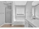 Modern bathroom with tub and shower combination at 516 Broad Head Pt, Suwanee, GA 30024
