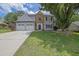 Beautifully landscaped two-story house with a two car garage, stone accents, and green lawn at 516 Broad Head Pt, Suwanee, GA 30024
