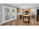Bright kitchen with stainless steel appliances, wooden cabinets, island, and access to the back patio at 516 Broad Head Pt, Suwanee, GA 30024
