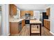 Well-lit kitchen with stainless steel appliances, wood cabinets, and an island at 516 Broad Head Pt, Suwanee, GA 30024
