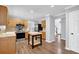 Spacious kitchen featuring wood cabinets, stainless steel appliances and access to front entry at 516 Broad Head Pt, Suwanee, GA 30024