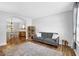 Bright living room featuring neutral walls, hardwood floors, and a comfortable gray sofa at 516 Broad Head Pt, Suwanee, GA 30024