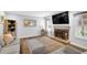 Bright living room with fireplace, large windows, and a comfortable seating area at 516 Broad Head Pt, Suwanee, GA 30024