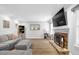 Inviting living room with a stone fireplace and large television at 516 Broad Head Pt, Suwanee, GA 30024