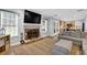 Open-concept living room with fireplace, natural light, and access to the kitchen at 516 Broad Head Pt, Suwanee, GA 30024