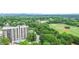 Scenic aerial view of the high rise building, surrounded by lush greenery and views of downtown at 1130 Piedmont Ne Ave # 803, Atlanta, GA 30309