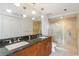 Spa-like bathroom boasts double sinks, granite countertops, and a glass-enclosed shower at 1130 Piedmont Ne Ave # 803, Atlanta, GA 30309