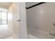 Bright bathroom showcases tiled shower and tub with black accent tiles at 1130 Piedmont Ne Ave # 803, Atlanta, GA 30309
