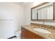Bathroom featuring granite countertop, decorative mirror and modern fixtures at 1130 Piedmont Ne Ave # 803, Atlanta, GA 30309