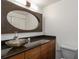 Chic bathroom features an oval mirror, vessel sink, and modern vanity at 1130 Piedmont Ne Ave # 803, Atlanta, GA 30309