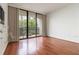 Open bedroom with hardwood floors and large glass doors that go to a balcony at 1130 Piedmont Ne Ave # 803, Atlanta, GA 30309