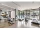 Well-equipped gym featuring treadmills, weight machines, and large windows overlooking the pool at 1130 Piedmont Ne Ave # 803, Atlanta, GA 30309