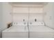 Convenient laundry room features a full-size washer and dryer with overhead shelving at 1130 Piedmont Ne Ave # 803, Atlanta, GA 30309