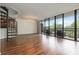 Open living area features hardwood floors, spiral staircase, and a large window with balcony at 1130 Piedmont Ne Ave # 803, Atlanta, GA 30309
