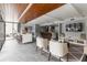Modern living room area with wood accents, stainless steel appliances, and luxury chairs and bar seating at 1130 Piedmont Ne Ave # 803, Atlanta, GA 30309