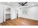 Bright bedroom features hardwood floors, a ceiling fan, and double closets with open doors at 1150 Rankin St # 6H, Stone Mountain, GA 30083