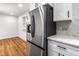 New stainless steel refrigerator and modern white cabinets enhance this kitchen space at 1150 Rankin St # 6H, Stone Mountain, GA 30083