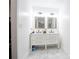 Modern bathroom features a double sink vanity with marble floors and bright lighting at 1285 Avon Sw Ave, Atlanta, GA 30310