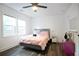 Comfortable bedroom with light pink bedding, natural light, and wood-look floors, creating a restful space at 1285 Avon Sw Ave, Atlanta, GA 30310
