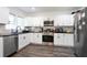 Modern kitchen with white cabinets, stainless steel appliances, and dark countertops, providing ample space at 1285 Avon Sw Ave, Atlanta, GA 30310