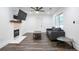 Cozy living room with a fireplace, dark sofa, and modern decor, creating a comfortable atmosphere at 1285 Avon Sw Ave, Atlanta, GA 30310