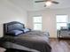Spacious main bedroom with a comfortable bed, two windows, and modern ceiling fan at 1285 Avon Sw Ave, Atlanta, GA 30310