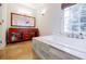 Well-lit bathroom with a soaking tub, a granite topped vanity, and tile floors at 2695 Rangewood Ne Dr, Atlanta, GA 30345