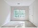This bedroom has a window with sunlight and a neutral wall and flooring color scheme at 2695 Rangewood Ne Dr, Atlanta, GA 30345