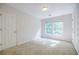 Cozy bedroom with neutral carpet, a window providing natural light, and a door at 2695 Rangewood Ne Dr, Atlanta, GA 30345