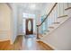 Inviting foyer with hardwood floors, a wooden staircase, and a decorative front door, creating a warm welcome at 2695 Rangewood Ne Dr, Atlanta, GA 30345