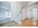 Open staircase with hardwood floors and white risers and banister, leading to an open area at 2695 Rangewood Ne Dr, Atlanta, GA 30345